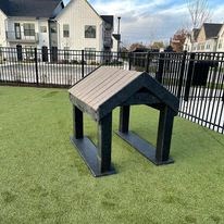 a picnic table in a yard in front of a fence