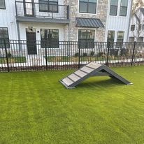 a ramp in the grass in front of a house