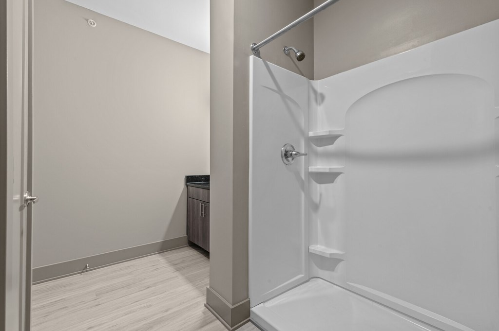 A white bathroom with a walk-in shower.