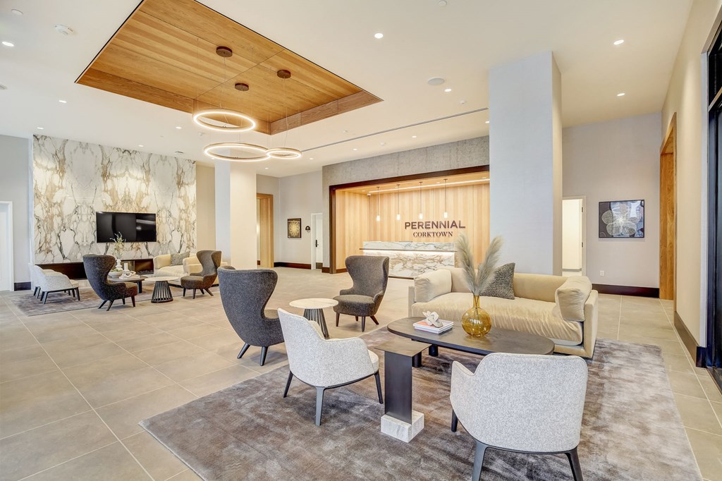 a lobby with a couch and tables and chairs