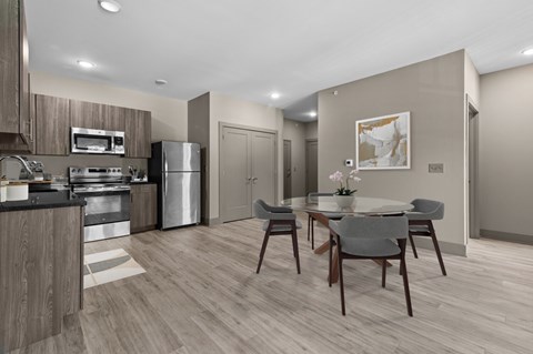 A modern kitchen with a dining table set for two.