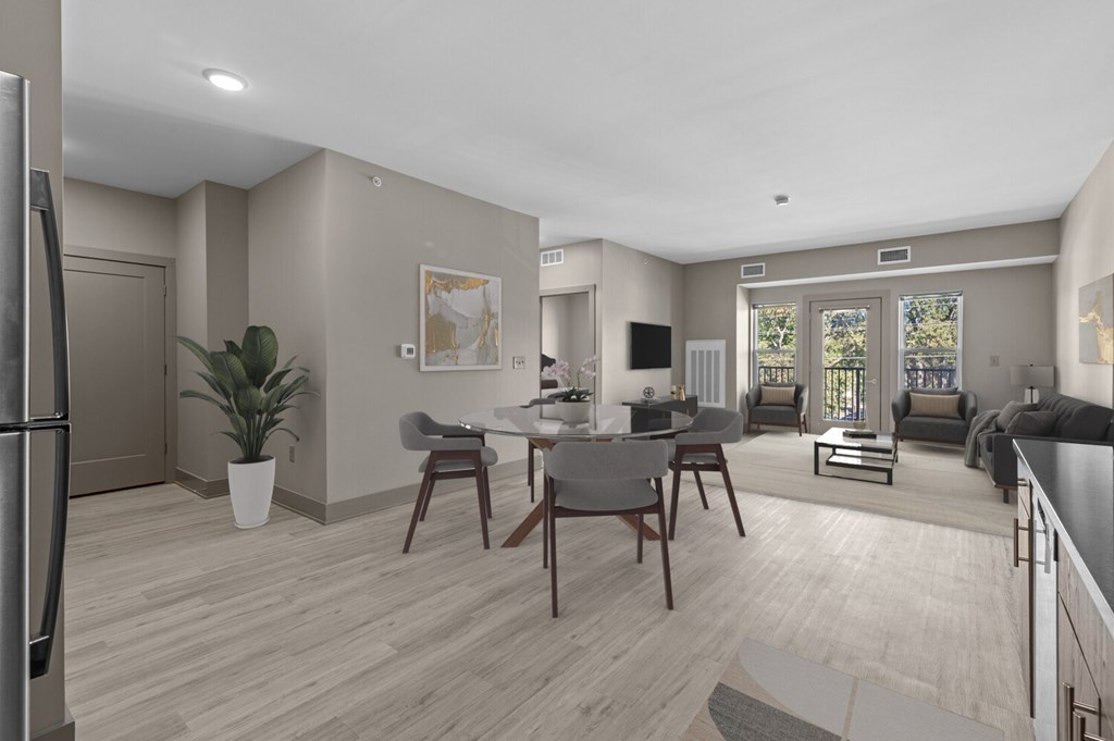 A modern kitchen with a dining table and chairs.