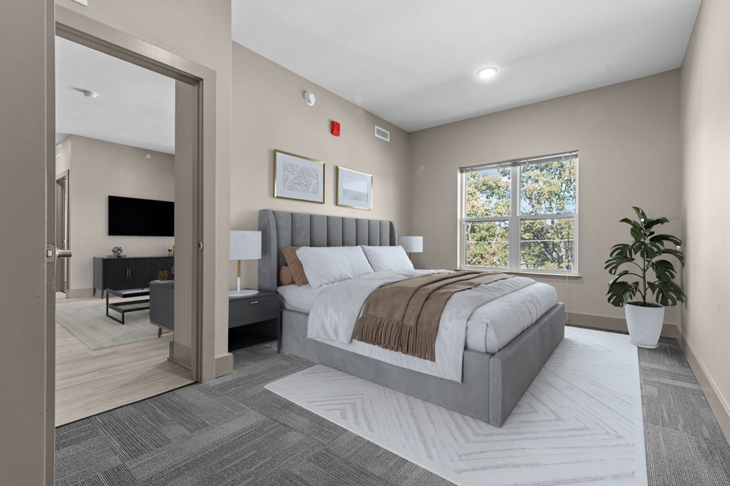 A modern bedroom with a large bed and a flat-screen TV.