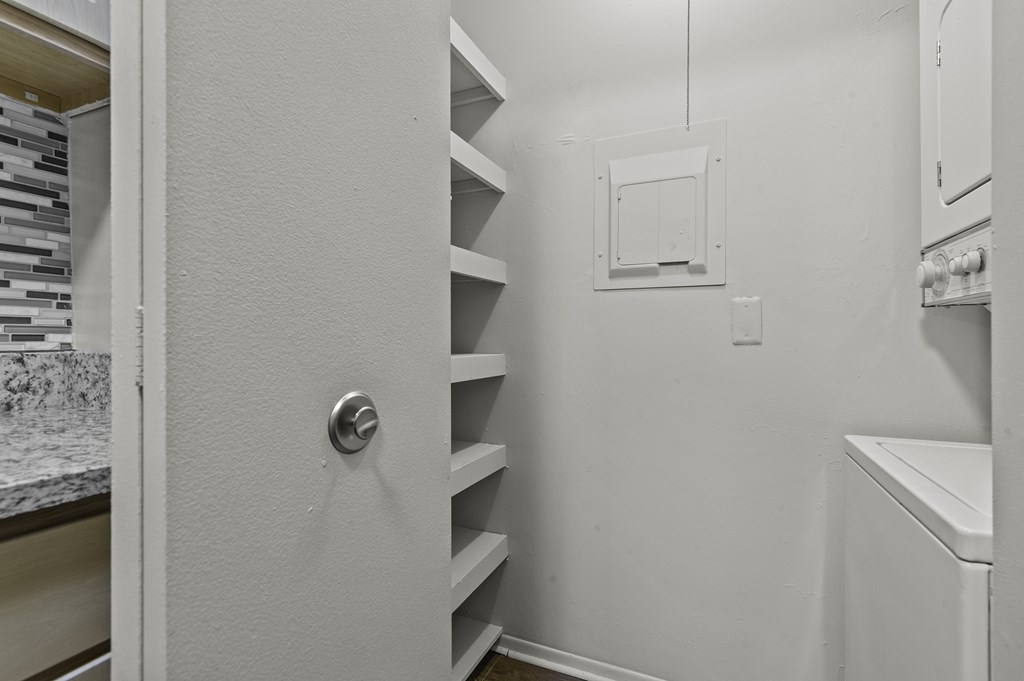 A white door with a silver handle is open.