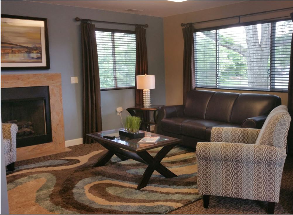 a living room with leather furniture and a fireplace
