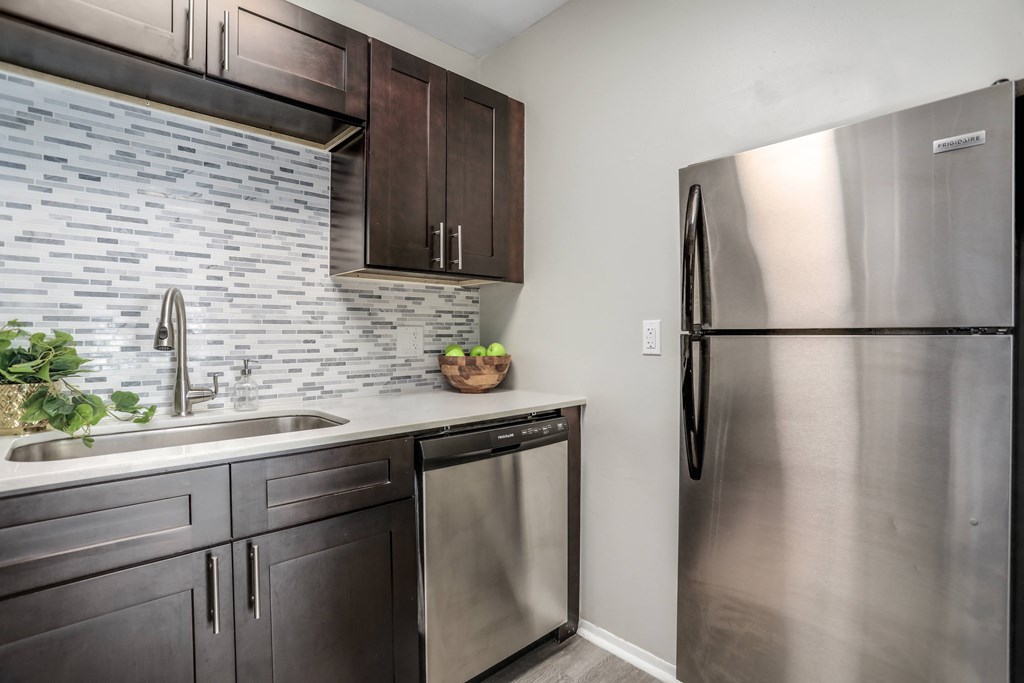 an apartment kitchen with stainless steel appliances and a stainless steel refrigerator