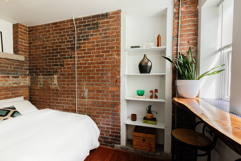 a bedroom with a bed and a window