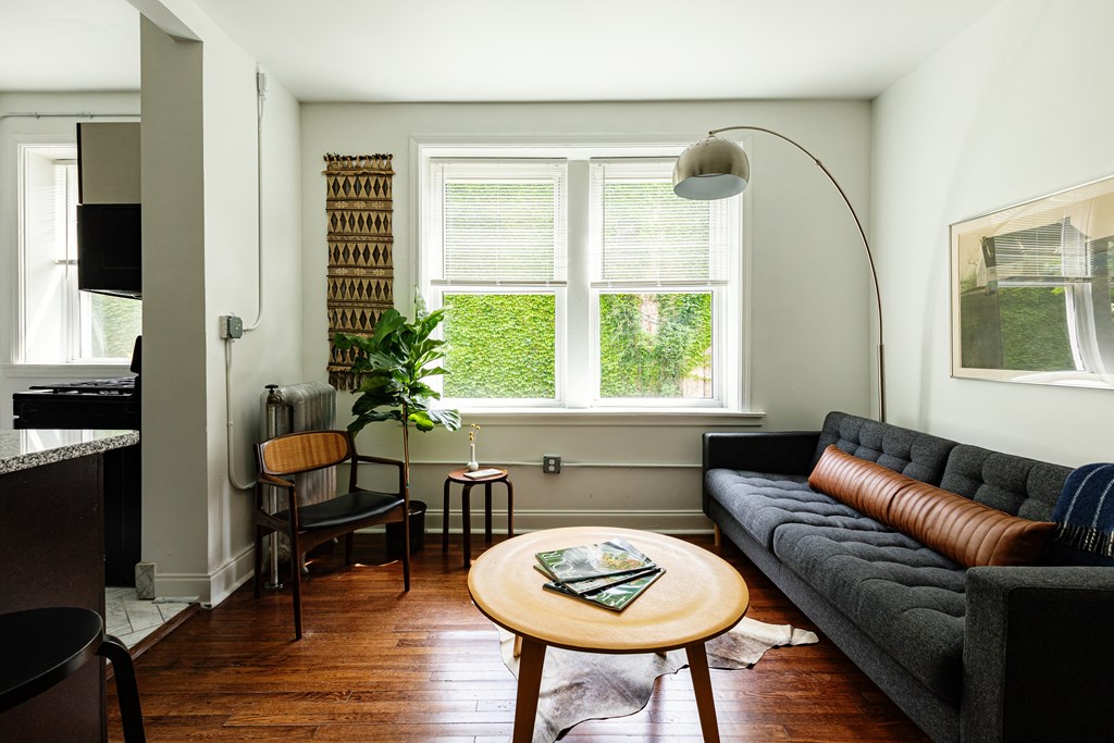 a living room with a gray couch and a round coffee table