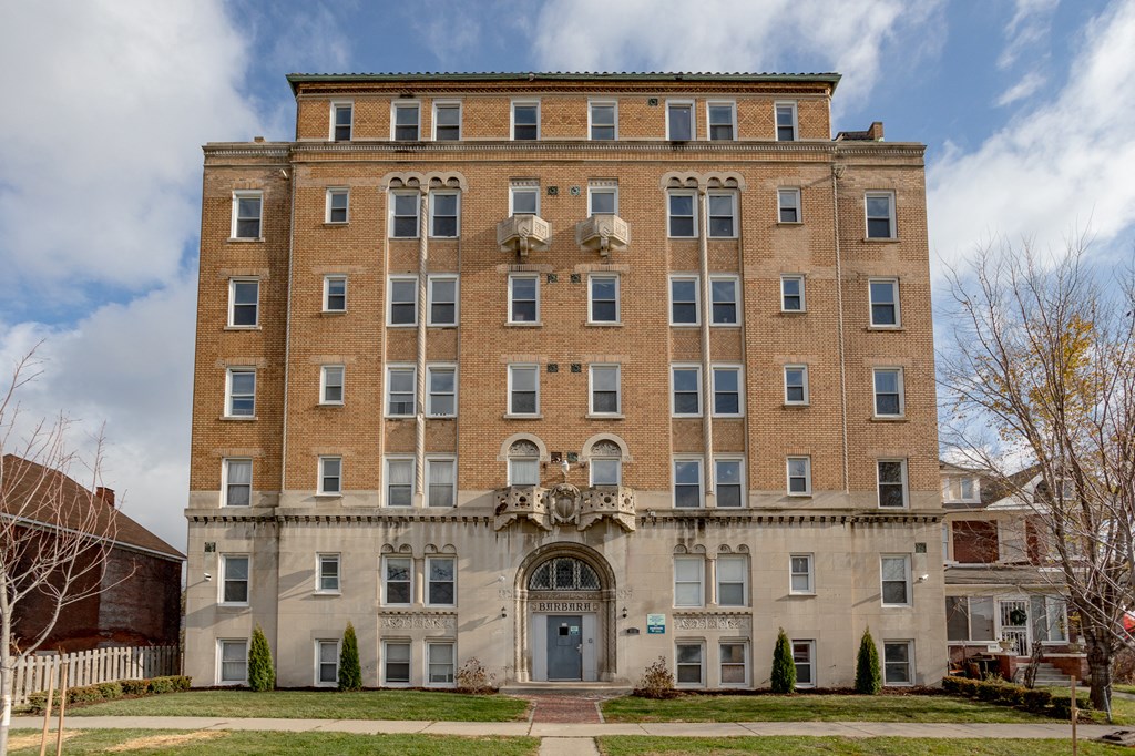 a large brick building with a blue sky in the background