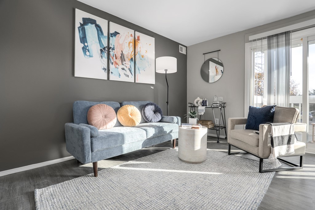 a living room with a blue couch and a chair