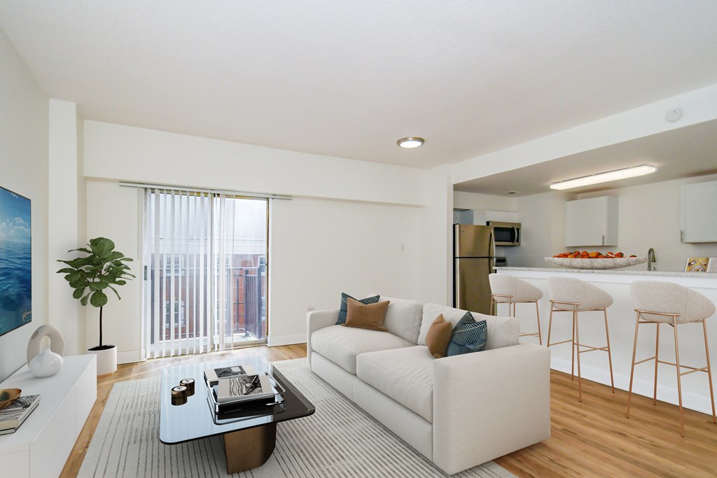 A modern living room with a white couch and a coffee table.