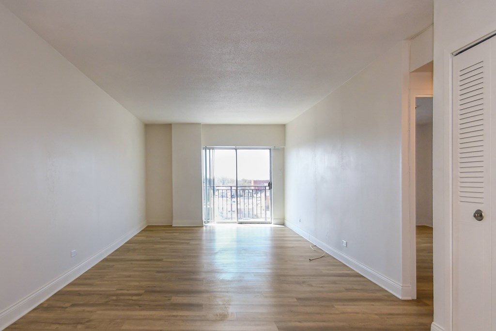 A room with wooden floors and white walls.