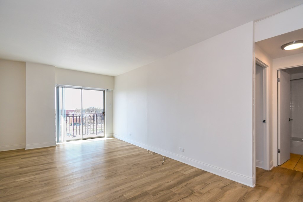 A room with wooden floors and white walls.