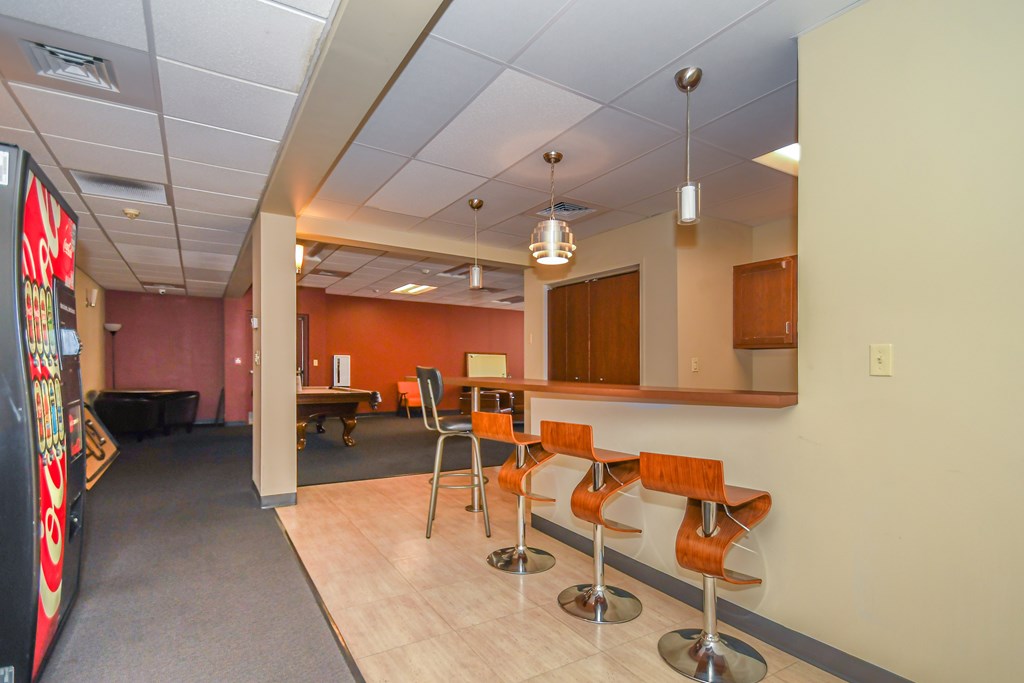 A conference room with a long table and chairs.