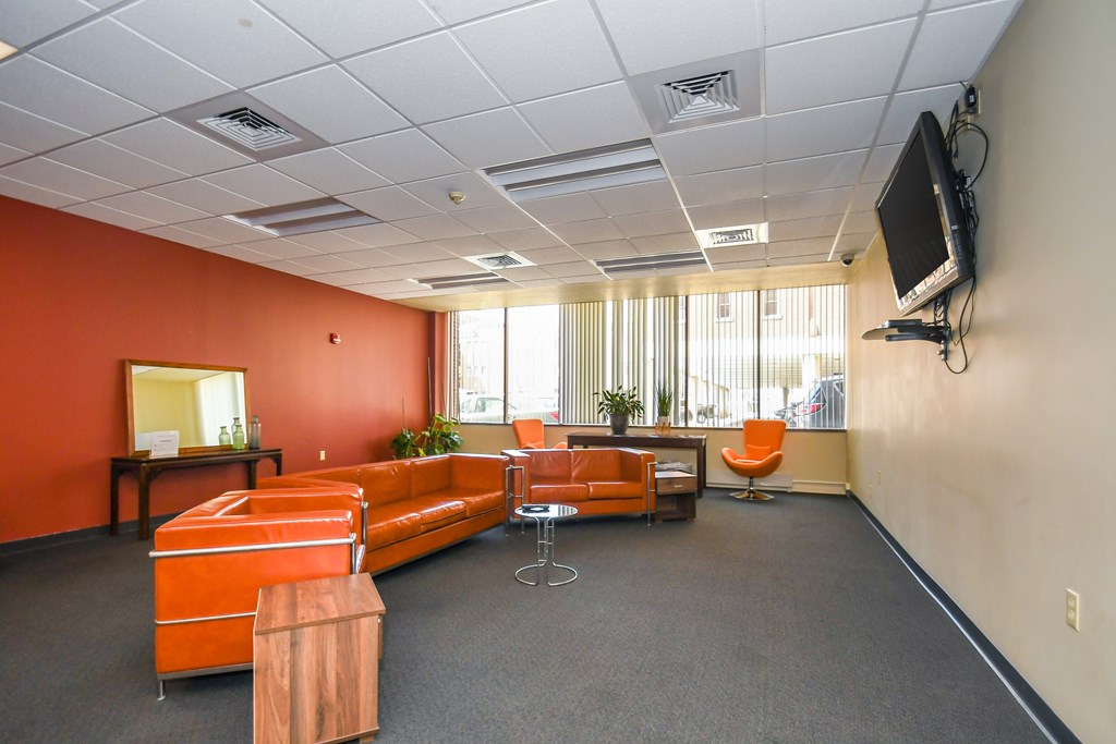 A room with orange walls and furniture.