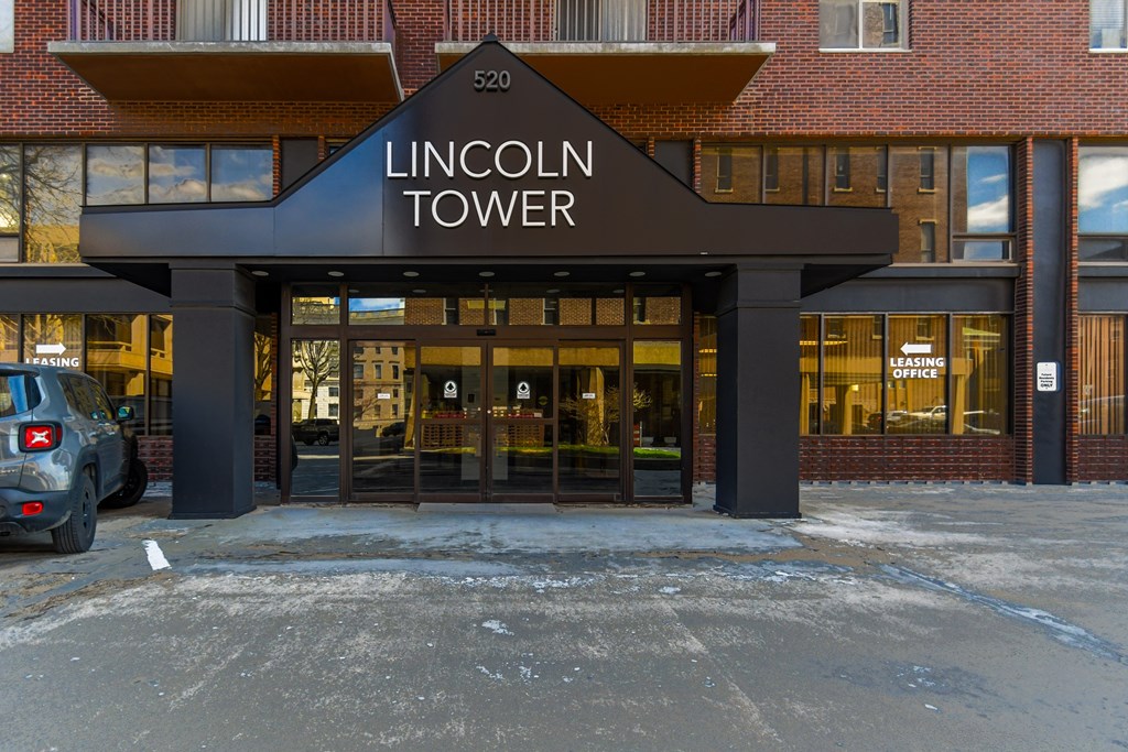 The Lincoln Tower is a multi-story building with a black awning and glass doors.