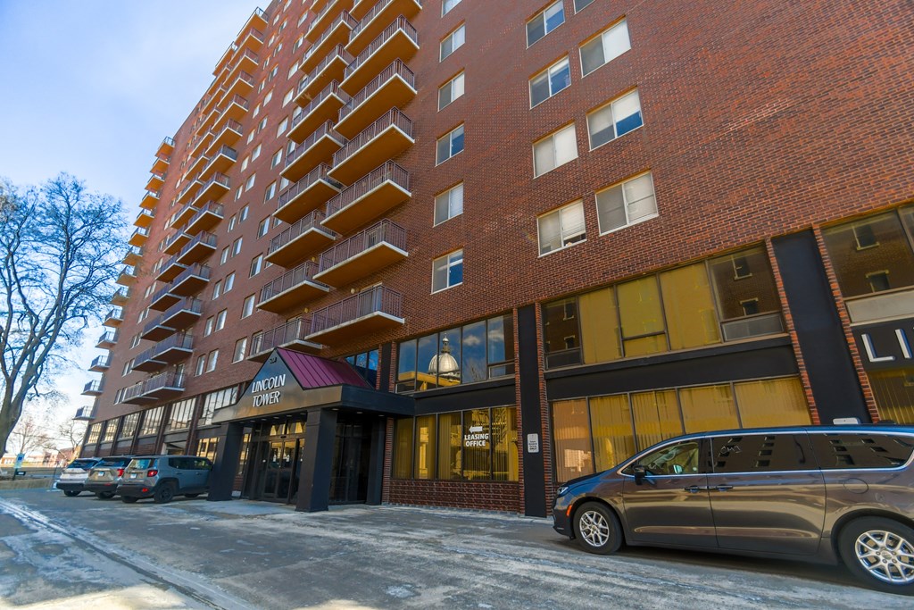 A tall red brick building with a sign that says "Lovely" on the front.