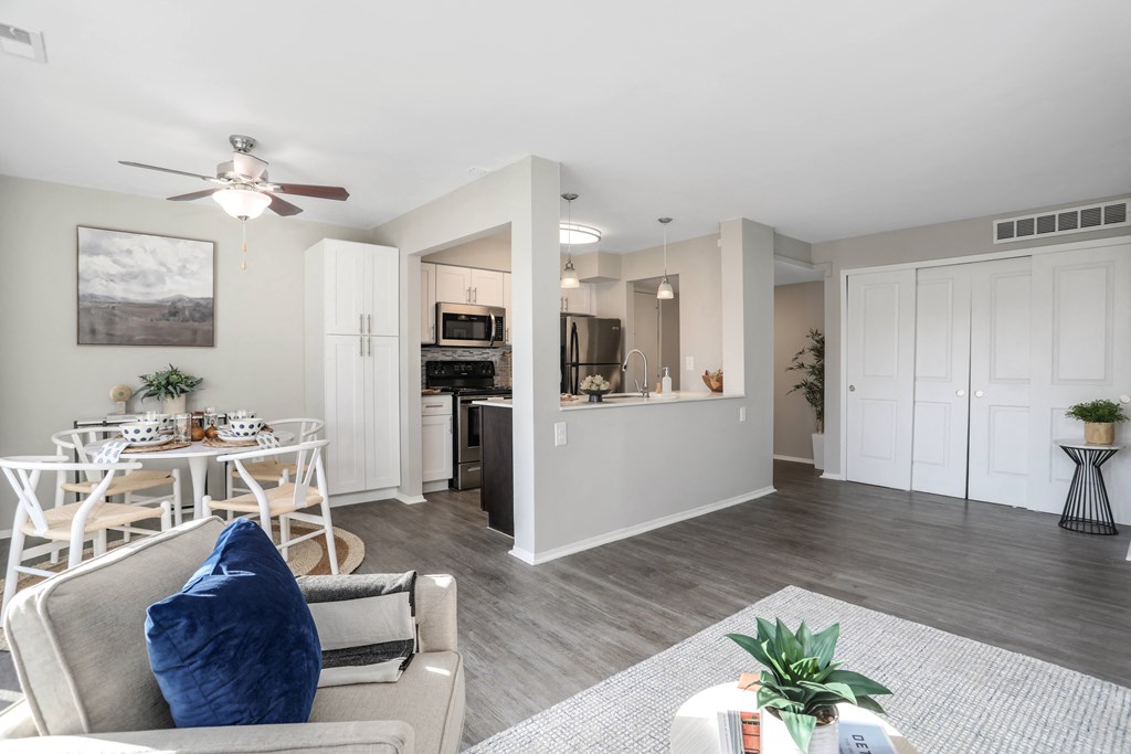 an open living room and kitchen with a ceiling fan