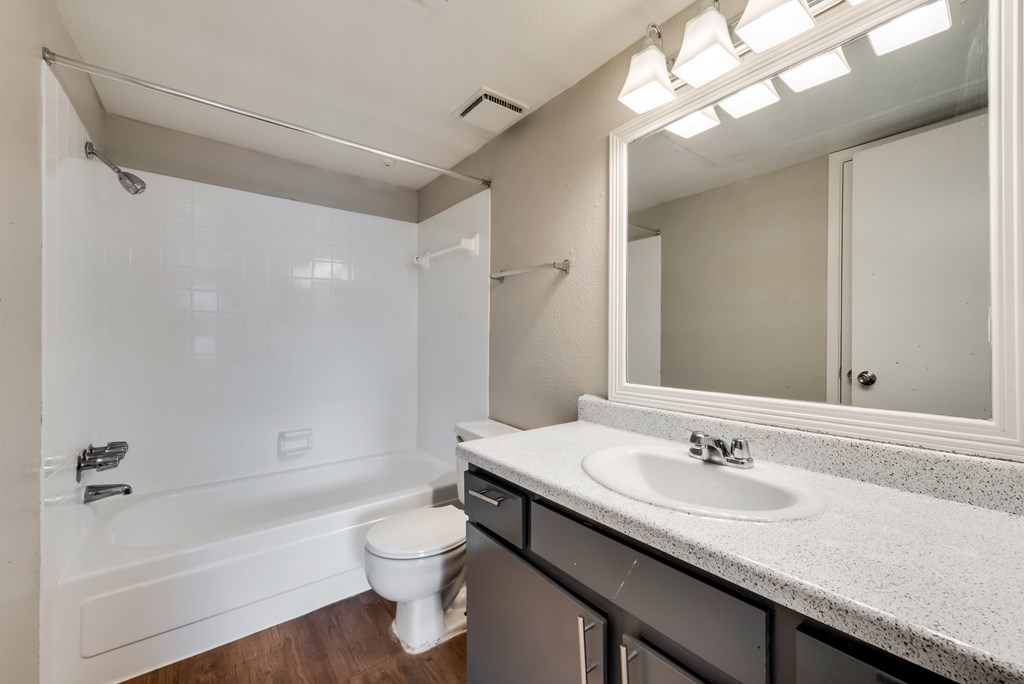 A white bathroom with a sink, toilet, and bathtub.