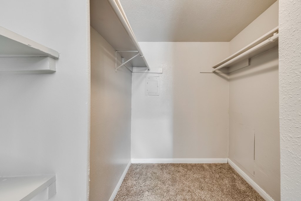 A small, empty room with a carpeted floor and white walls.