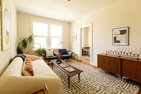 a living room with a couch and a rug