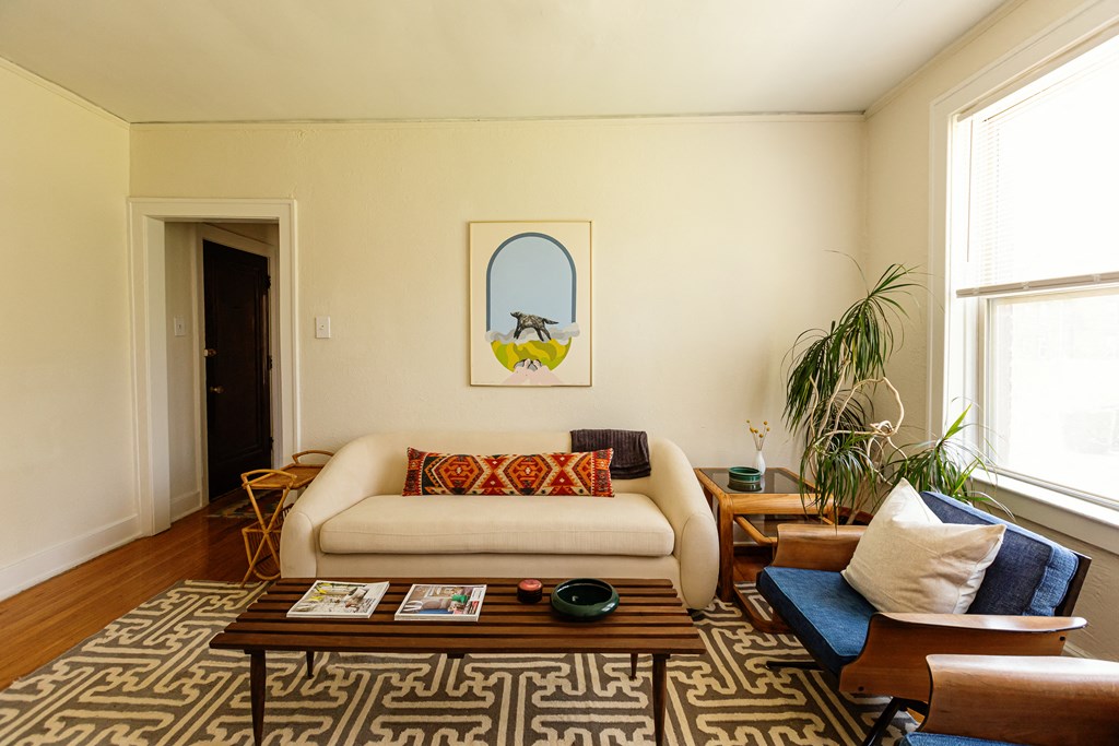 a living room with a couch and chairs