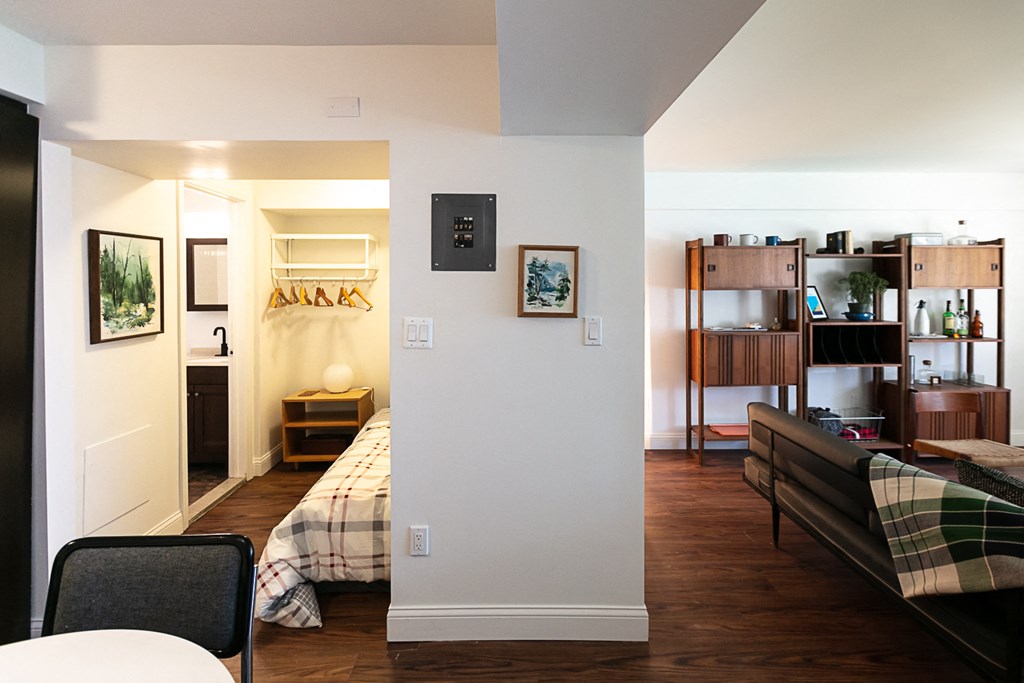 a bedroom with a bed and a couch in a room