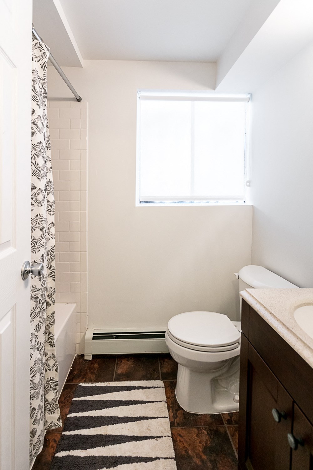 a bathroom with a toilet sink and shower