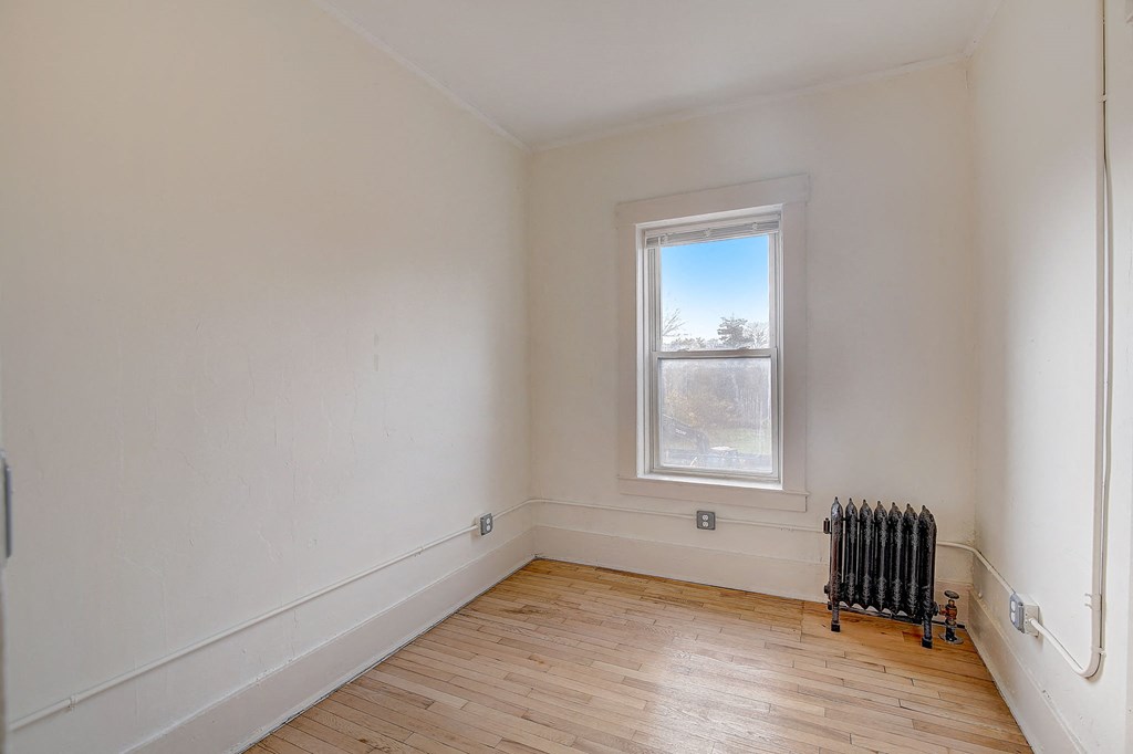 a living room with a radiator and a window