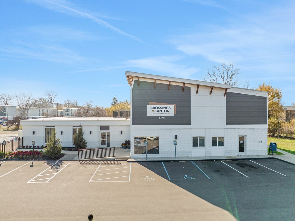 a white building with a parking lot in front of it