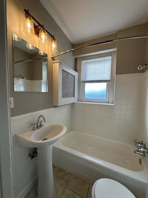 a bathroom with a sink toilet and a bath tub
