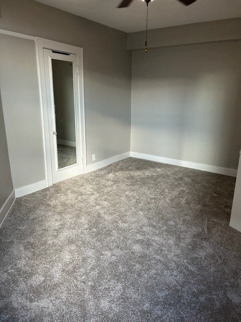 an empty room with a carpeted floor and a door