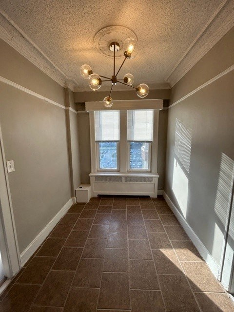 a hallway with a large window and a chandelier