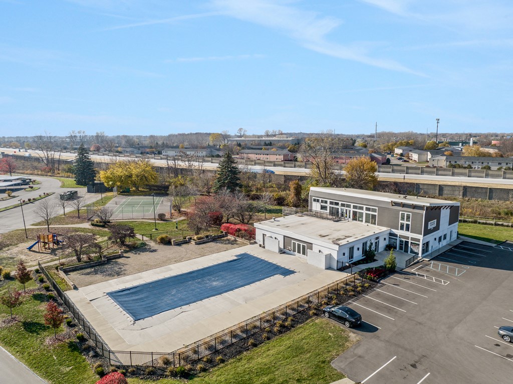 an aerial view of a school building and a parking lot