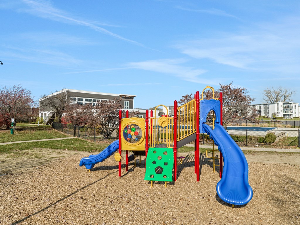 a playground in a park with a blue sky