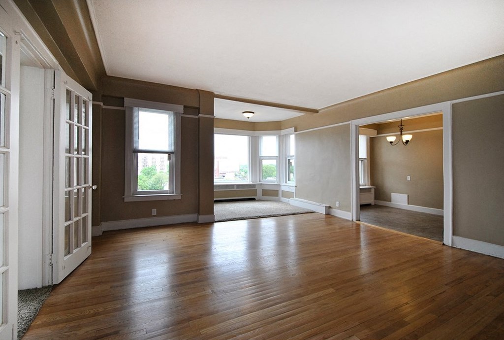 Living/Dining room with hard wood floors and carpeted reading nook.