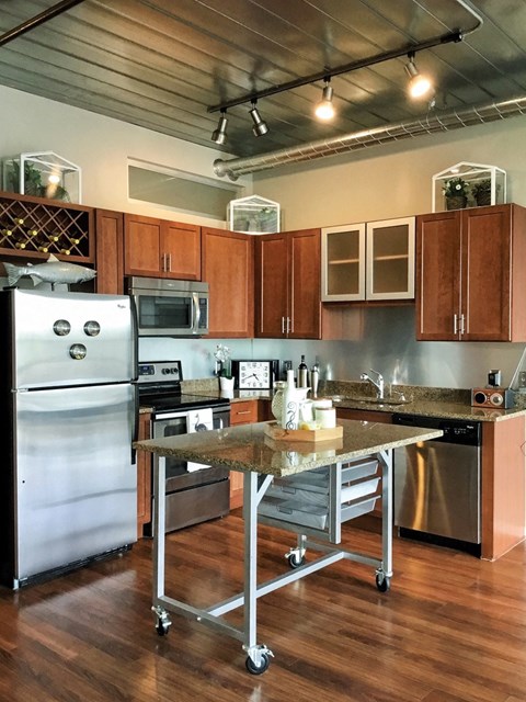 a kitchen with stainless steel appliances and a table