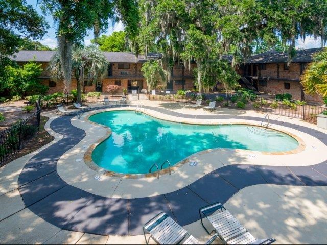a large swimming pool with chairs around it