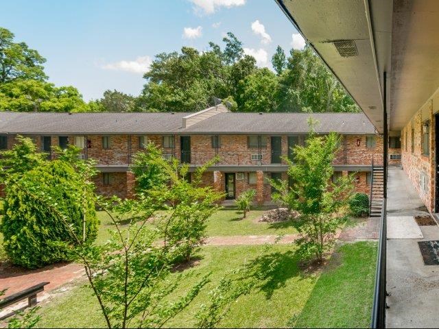a large brick building with a yard in front of it