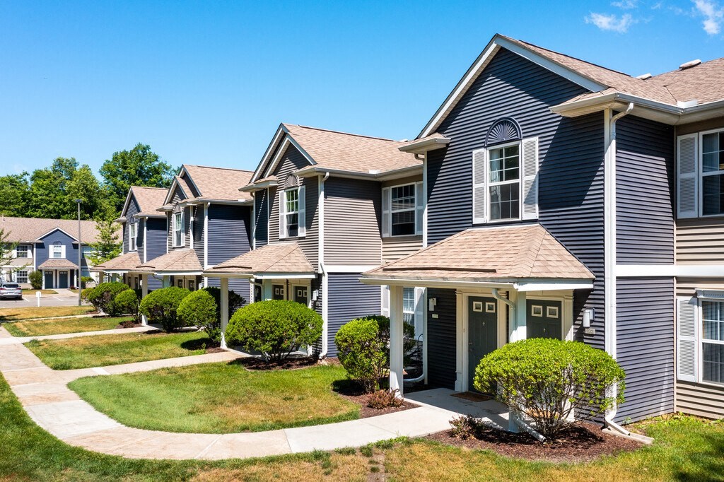 the view of a row of suburban homes on a sidewalk