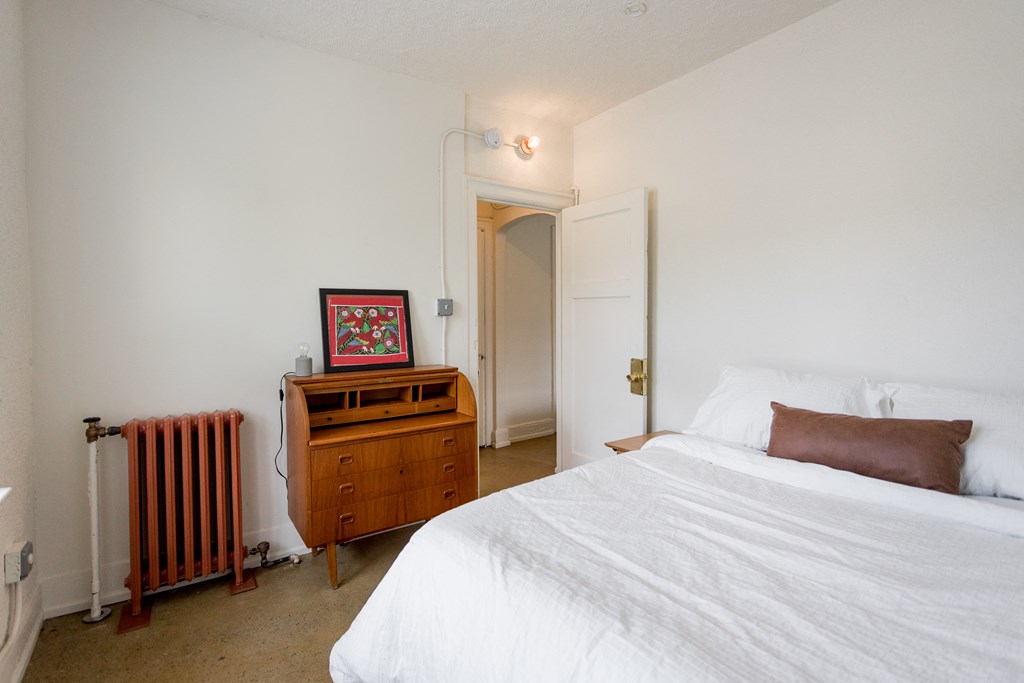 a bedroom with a bed and a dresser