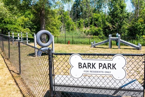 a park with a playground and a bark park for residents only