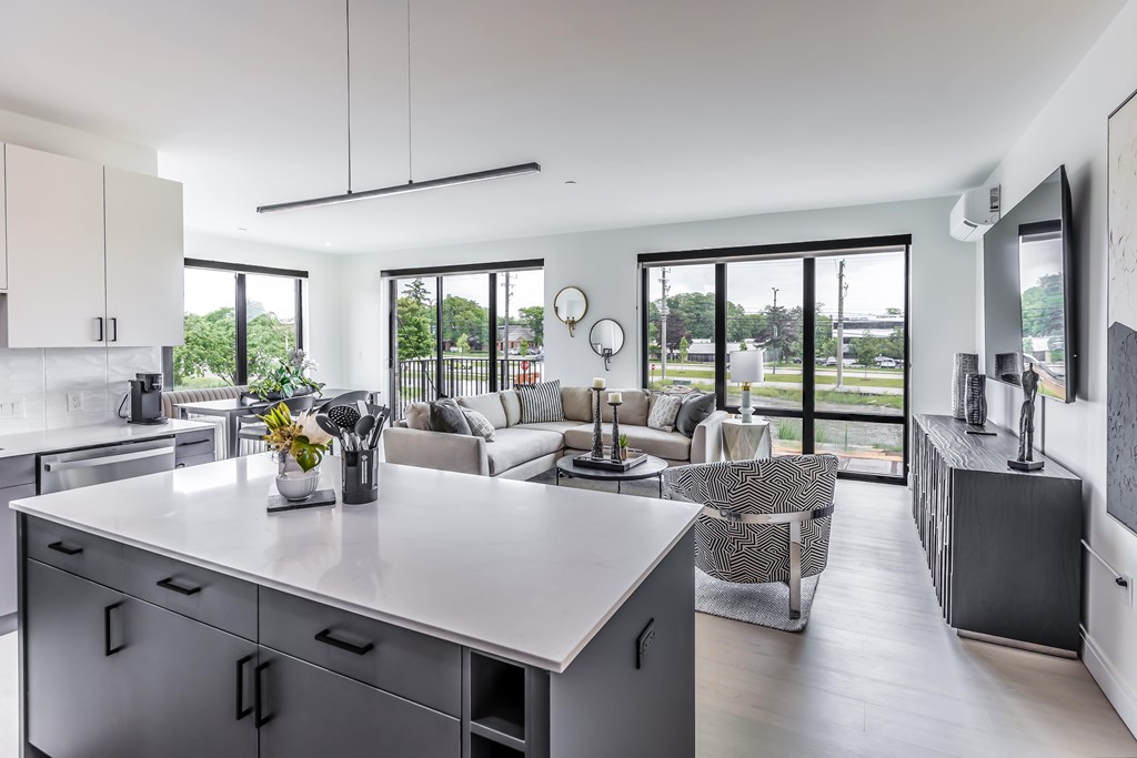 a kitchen with a large island and a living room with couches
