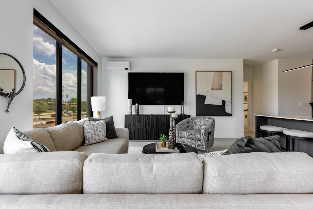 a living room with a couch and a chair and a television