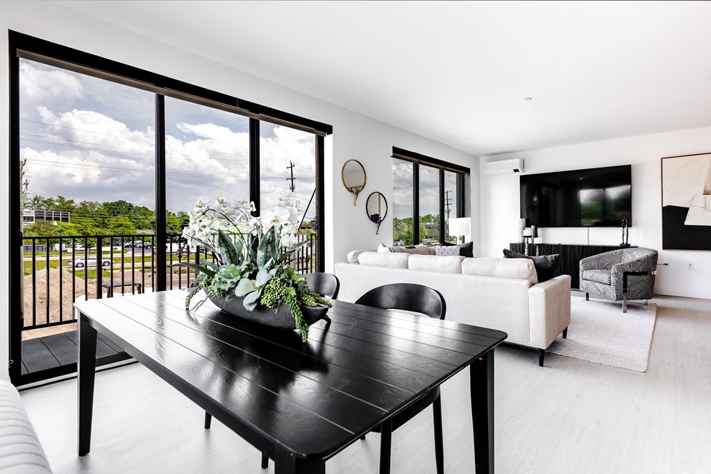 Living room and dining room area with large oversized windows