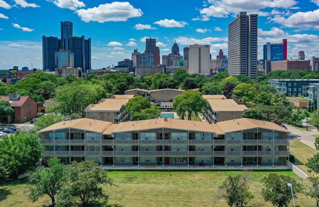 an aerial view of a building with a city in the background