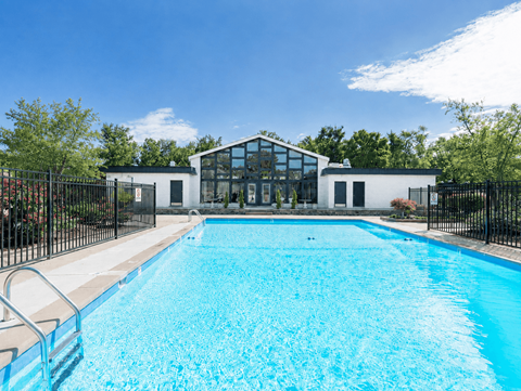 A swimming pool in front of a modern building.
