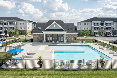 Overview of the clubhouse and pool, various seats around pool.