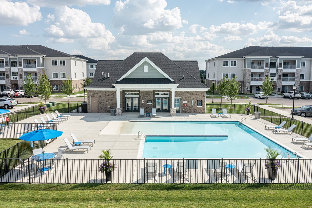 Overview of the clubhouse and pool, various seats around pool.