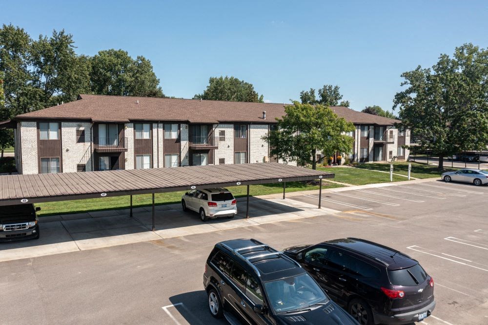 a parking lot in front of an apartment complex